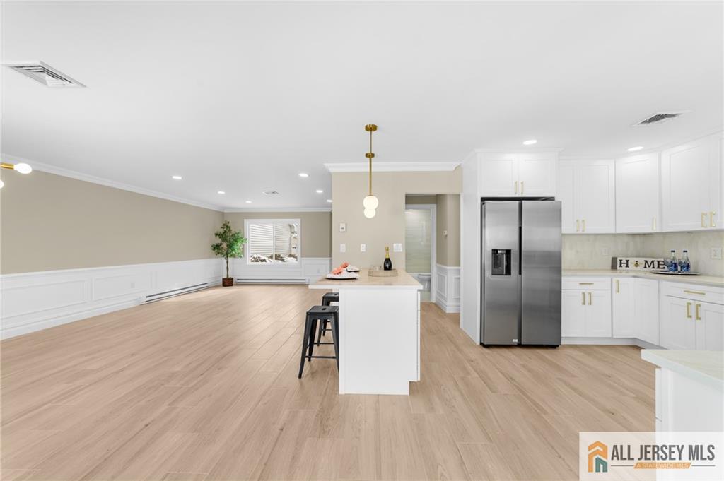 747 Marlton Road, Unit 747A Monroe Township, NJ 08831 - Photo 11 of 30 a view of a kitchen with refrigerator microwave and wooden floor