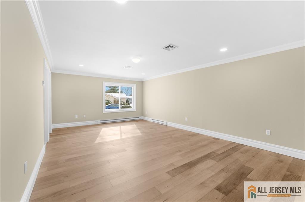 747 Marlton Road, Unit 747A Monroe Township, NJ 08831 - Photo 19 of 30 wooden floor in an empty room with a window