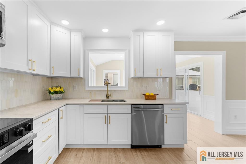 747 Marlton Road, Unit 747A Monroe Township, NJ 08831 - Photo 9 of 30 a kitchen with white cabinets and sink