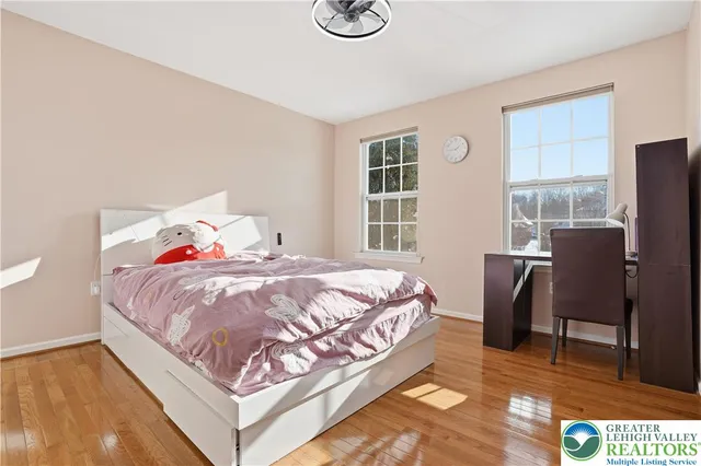 a bed sitting in a bedroom next to a window