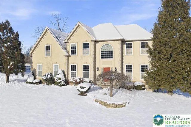 a view of a white house with a yard in front of it