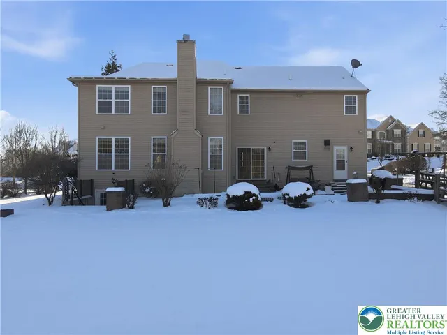a view of a house with yard and sitting area