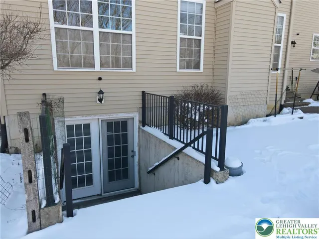 a view of a house with a snow in the yard