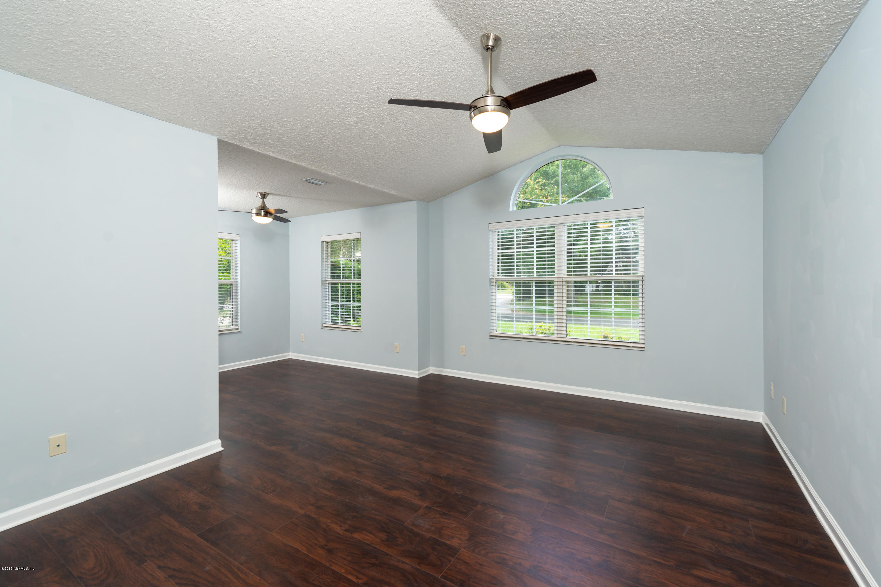 107 Mohegan Road St. Augustine, FL 32086 - Photo 13 of 38 a view of an empty room with wooden floor and a window