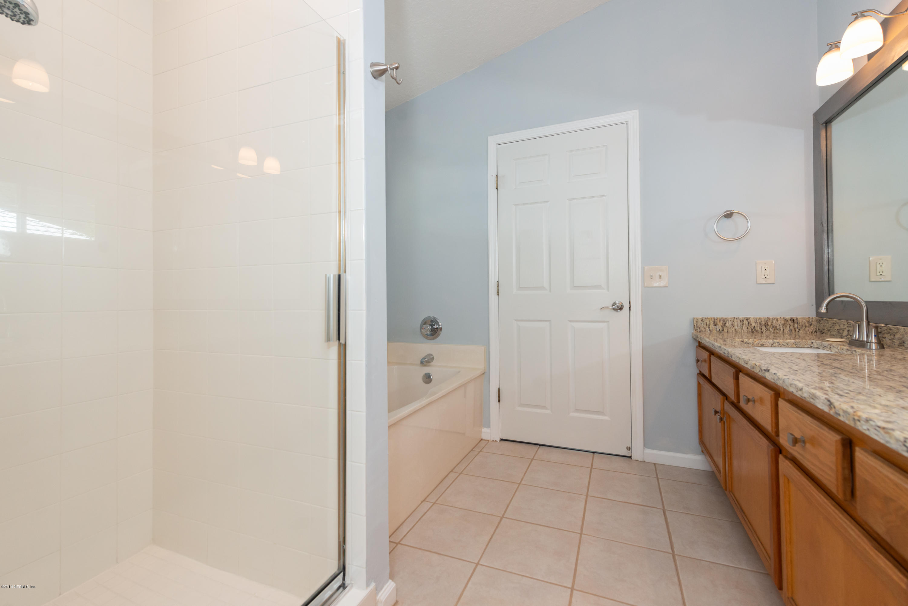 107 Mohegan Road St. Augustine, FL 32086 - Photo 18 of 38 a bathroom with a granite countertop sink a mirror and a bathtub