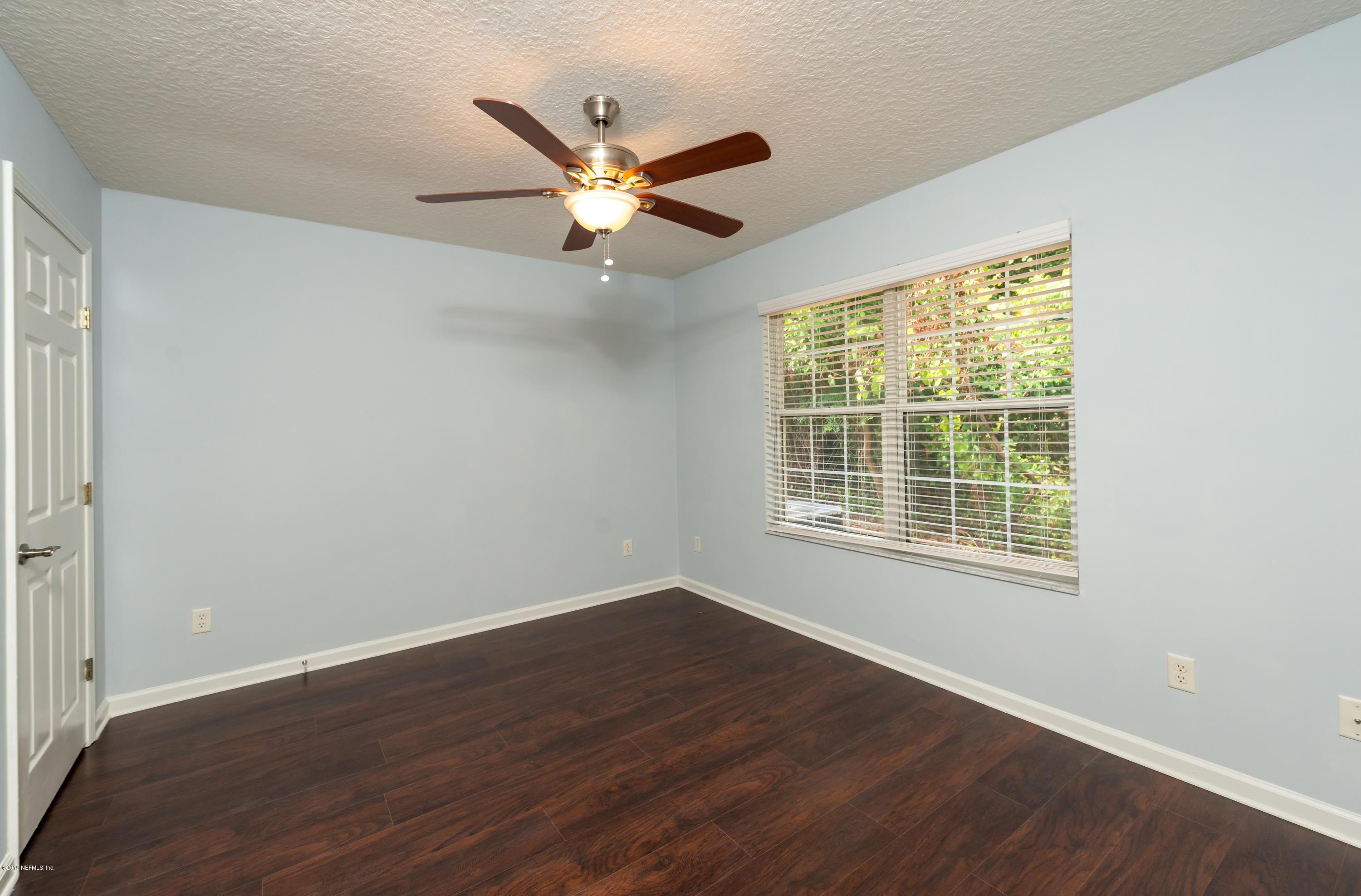 107 Mohegan Road St. Augustine, FL 32086 - Photo 19 of 38 a view of an empty room with wooden floor and a window