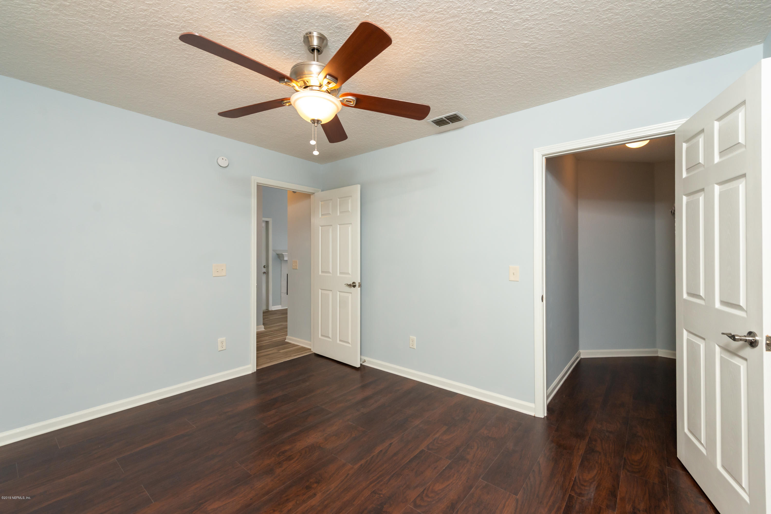 107 Mohegan Road St. Augustine, FL 32086 - Photo 22 of 38 an empty room with wooden floor fan and windows