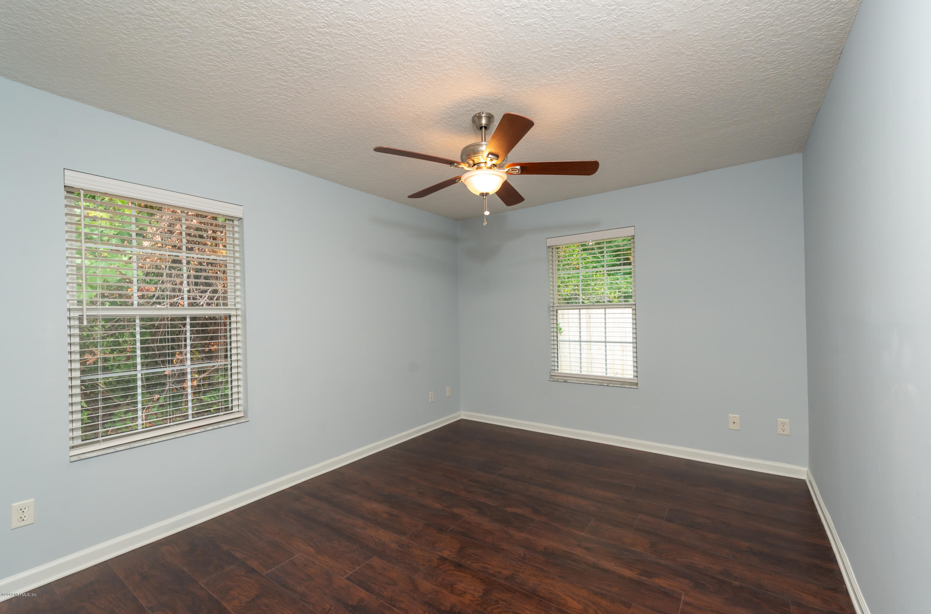 107 Mohegan Road St. Augustine, FL 32086 - Photo 23 of 38 a view of an empty room with wooden floor and a window