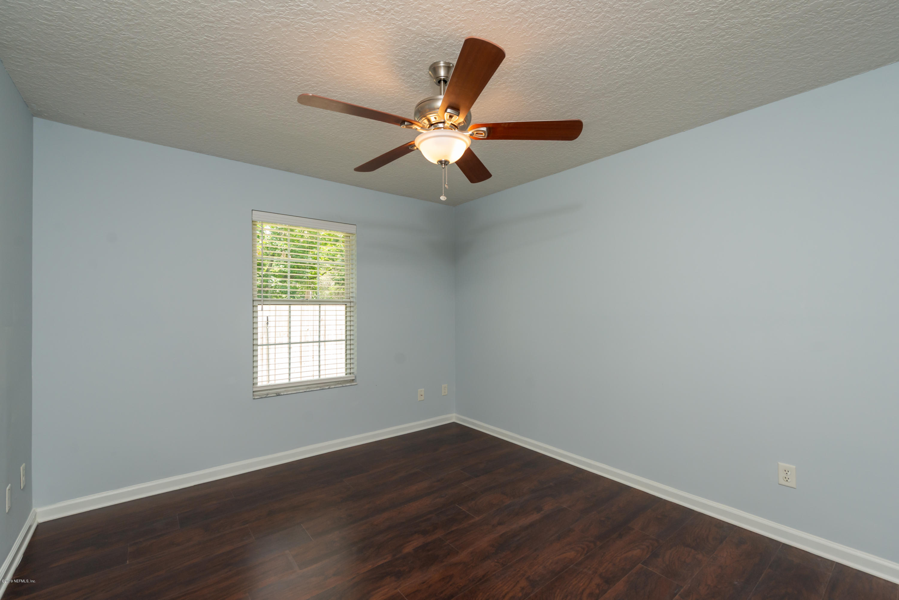 107 Mohegan Road St. Augustine, FL 32086 - Photo 24 of 38 an empty room with wooden floor fan and windows