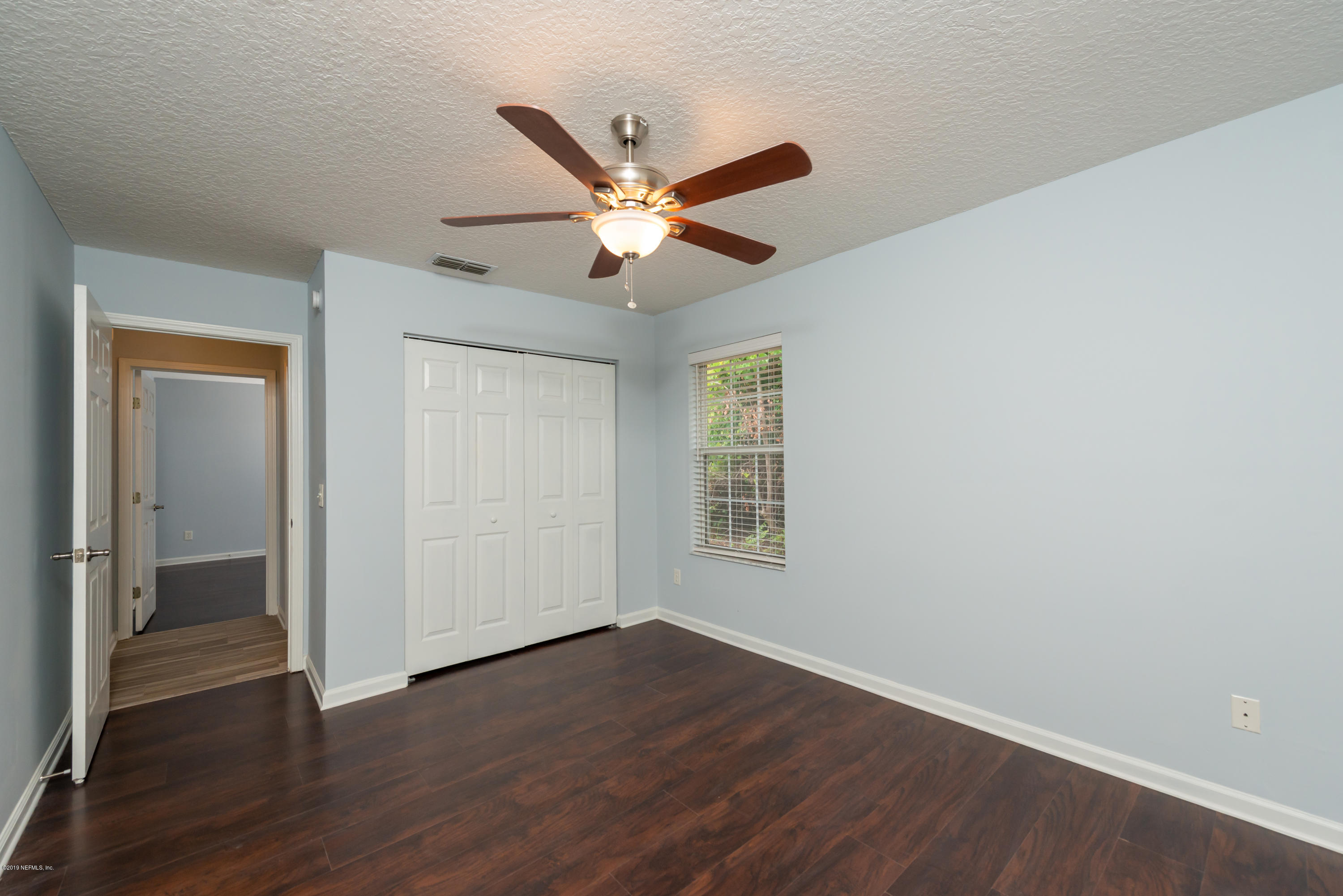 107 Mohegan Road St. Augustine, FL 32086 - Photo 26 of 38 wooden floor in an empty room with a window