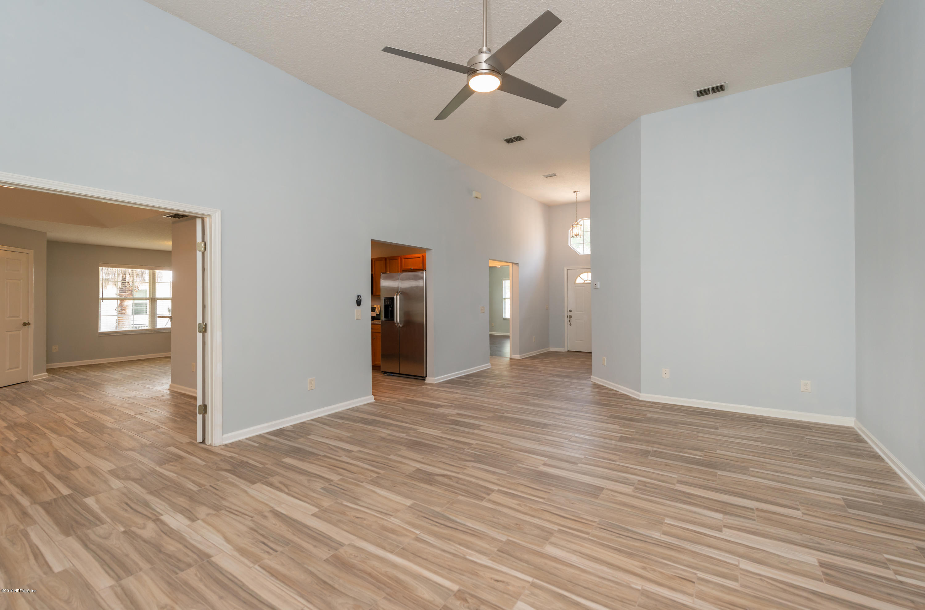 107 Mohegan Road St. Augustine, FL 32086 - Photo 3 of 38 wooden floor in an empty room with a window