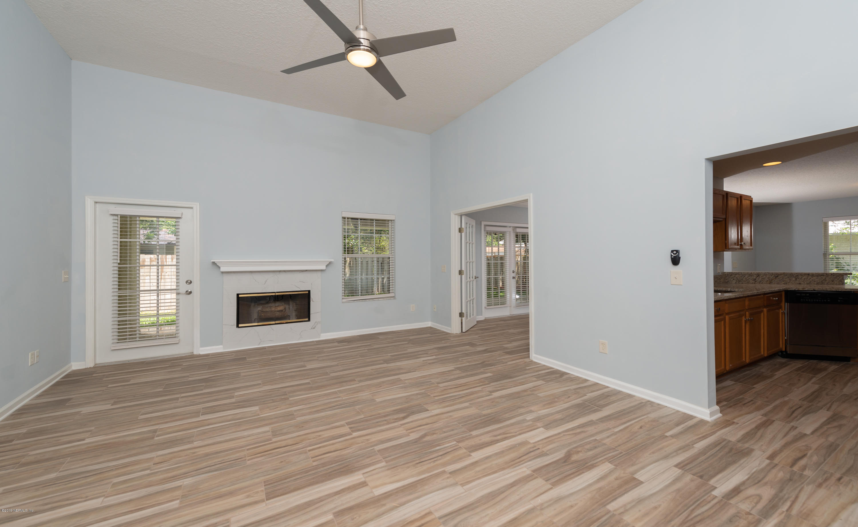 107 Mohegan Road St. Augustine, FL 32086 - Photo 4 of 38 a view of empty room with wooden floor and fireplace