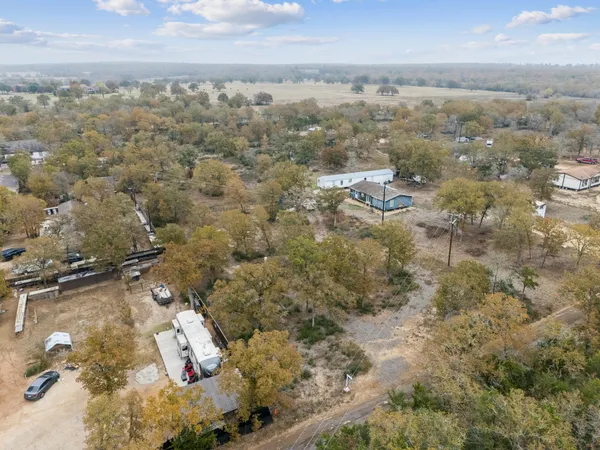 an aerial view of a house with a yard