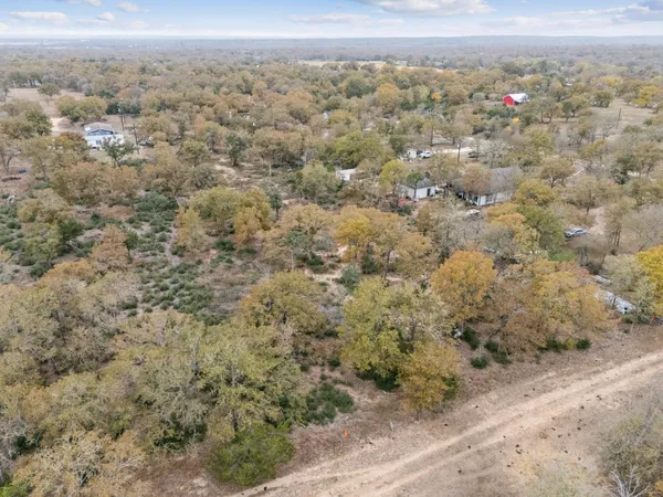 an aerial view of a house with a mountain
