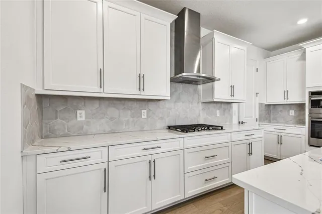 a kitchen with white cabinets and white appliances