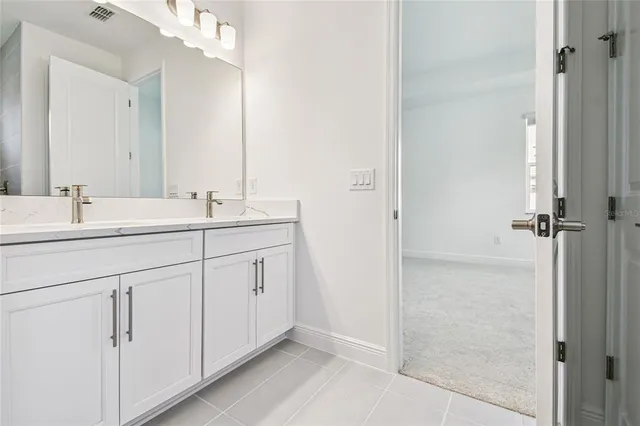 a bathroom with a double vanity sink mirror and