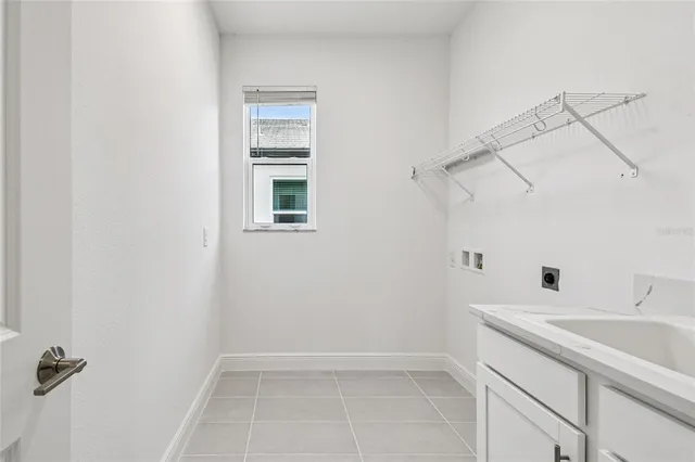 a view of a bathroom with a sink and cabinets