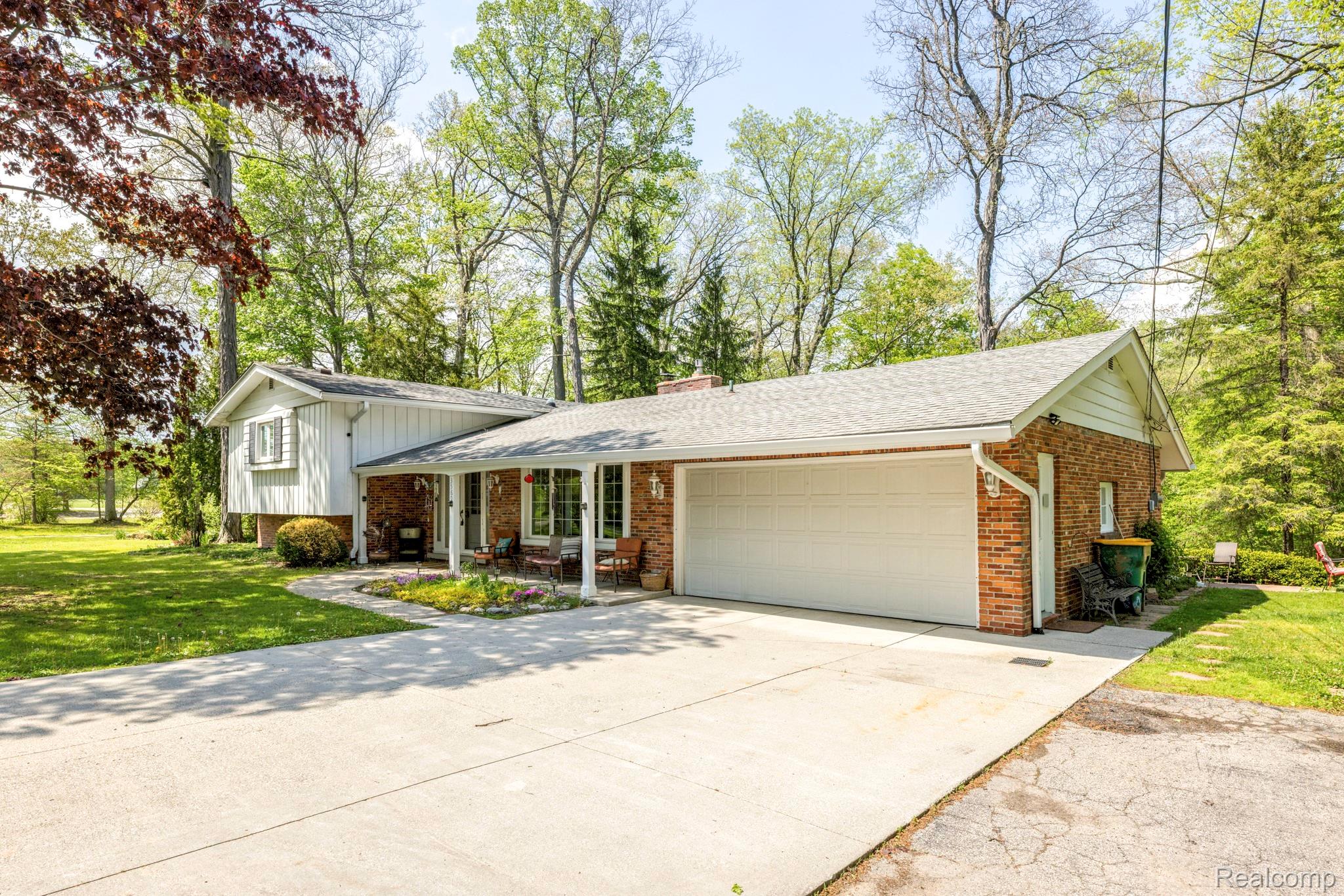3560 North Road North Street, MI 48049 - Photo 47 of 53 Split level home featuring driveway, an attached garage, brick siding, a front lawn, and roof with shingles