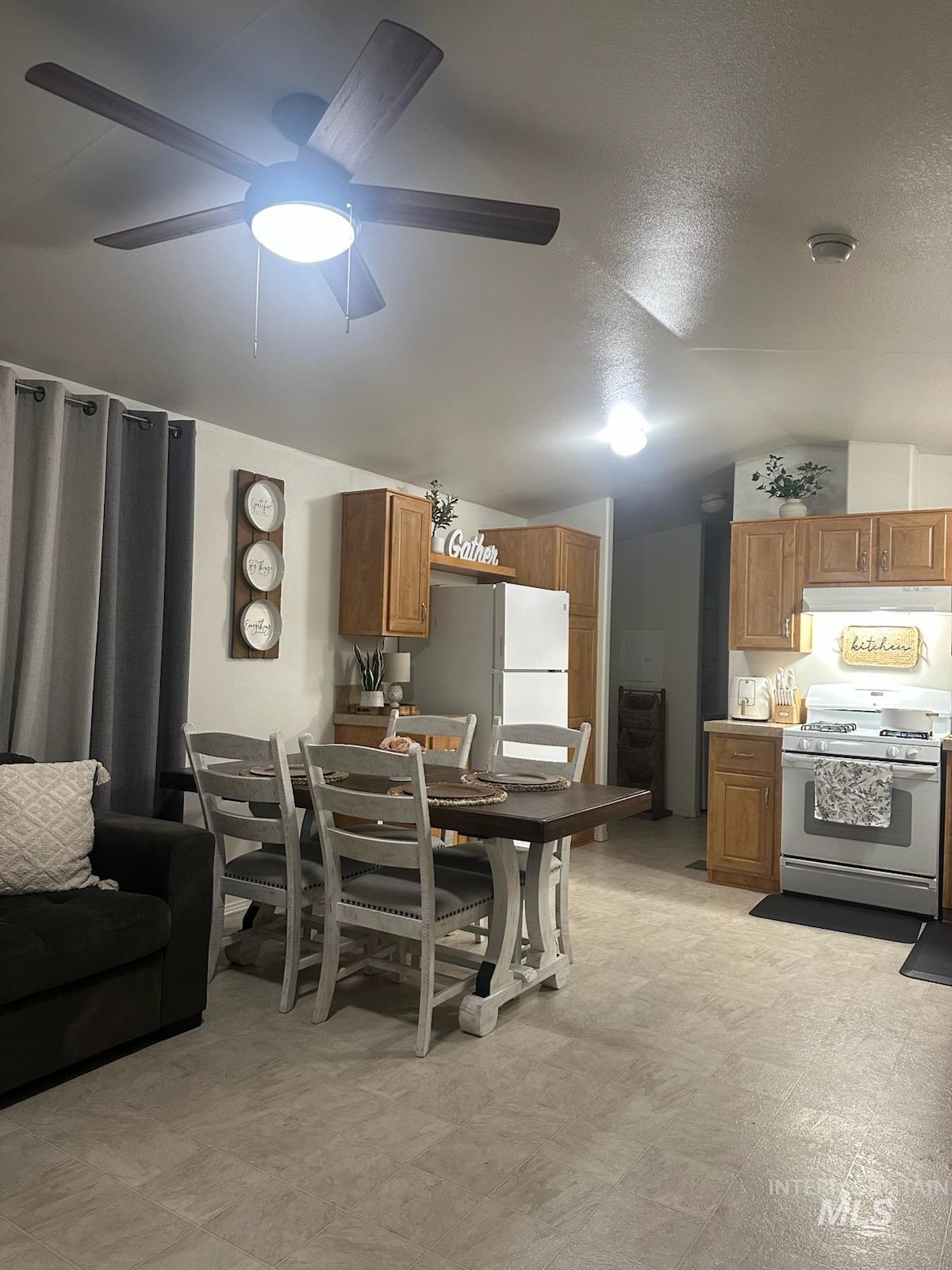 1171 North Sable Lane Boise, ID 83704 - Photo 11 of 19 Dining area with vaulted ceiling, light flooring, a textured ceiling, and ceiling fan