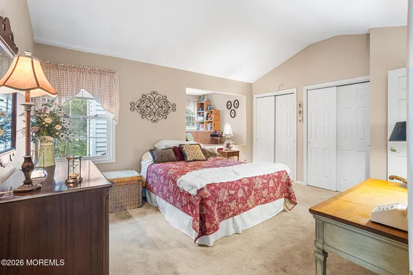 a bedroom with a bed and a couch