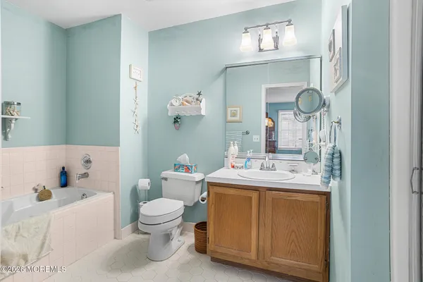a bathroom with a sink a toilet and a mirror