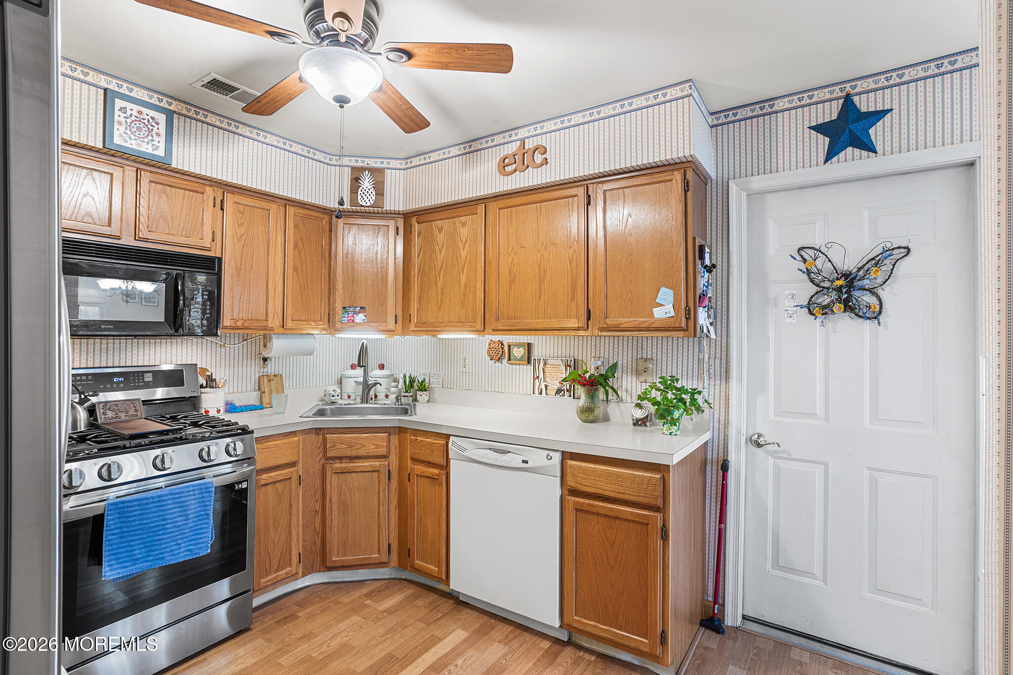 11 Browning Court Freehold, NJ 07728 - Photo 8 of 34 a kitchen with stainless steel appliances a stove a sink and a microwave