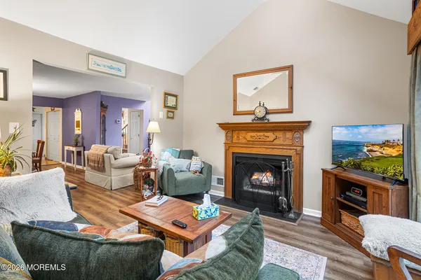 a living room with furniture a fireplace and a flat screen tv