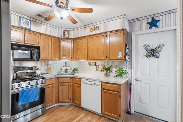 a kitchen with stainless steel appliances a stove a sink and a microwave