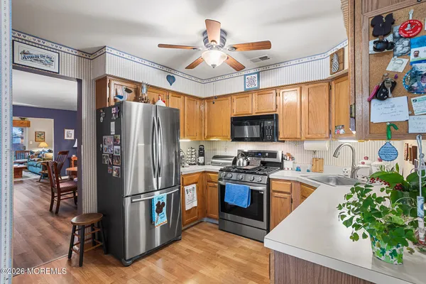 a kitchen with stainless steel appliances granite countertop a refrigerator a stove top oven a sink and dishwasher