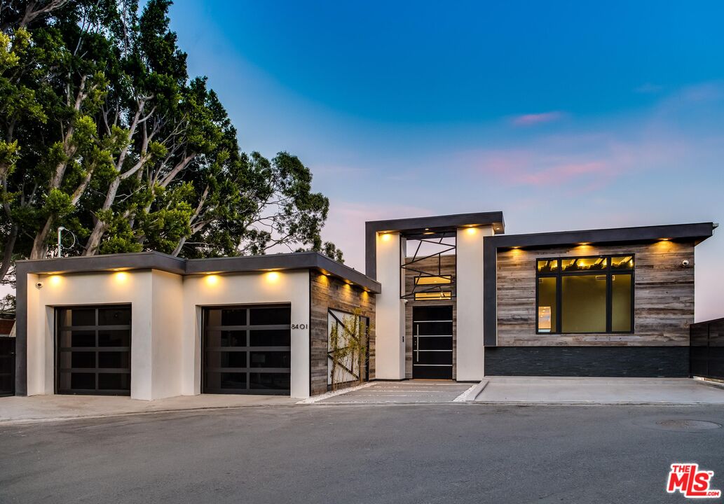 an entrance to house with yard and parking space