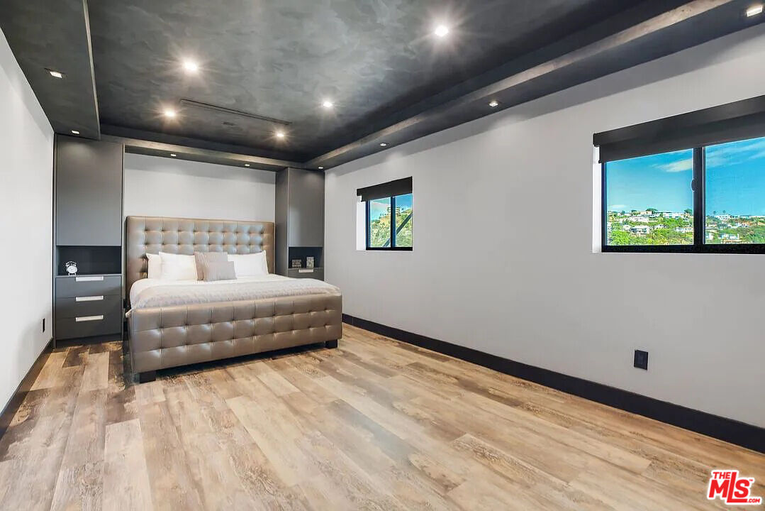 8401 Wyndham Road Los Angeles, CA 90046 - Photo 14 of 34 a spacious bedroom with a bed and a large window