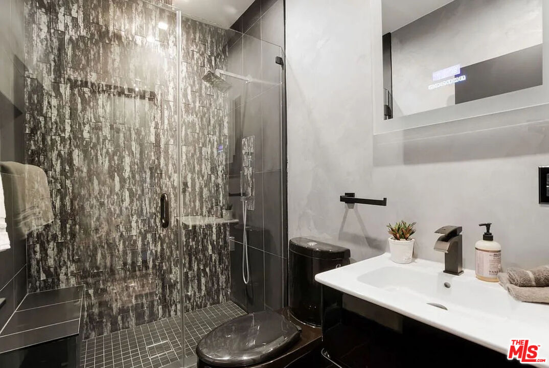 8401 Wyndham Road Los Angeles, CA 90046 - Photo 15 of 34 a bathroom with a sink and mirror
