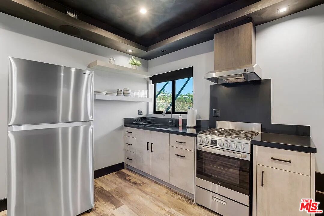 8401 Wyndham Road Los Angeles, CA 90046 - Photo 16 of 34 a kitchen with stainless steel appliances a stove and a refrigerator