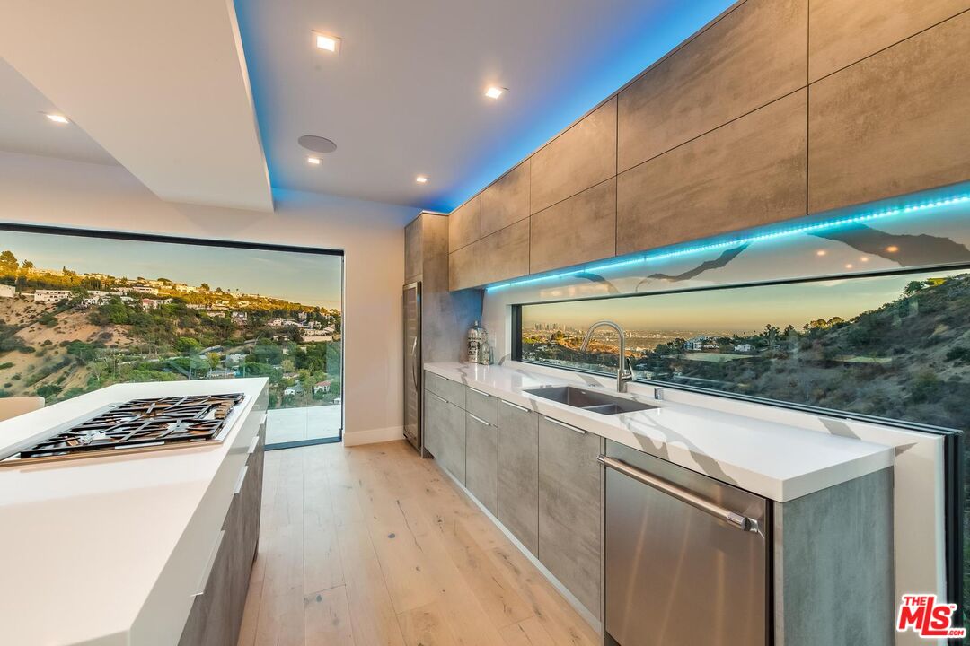 8401 Wyndham Road Los Angeles, CA 90046 - Photo 21 of 34 a kitchen with stainless steel appliances a sink and stove
