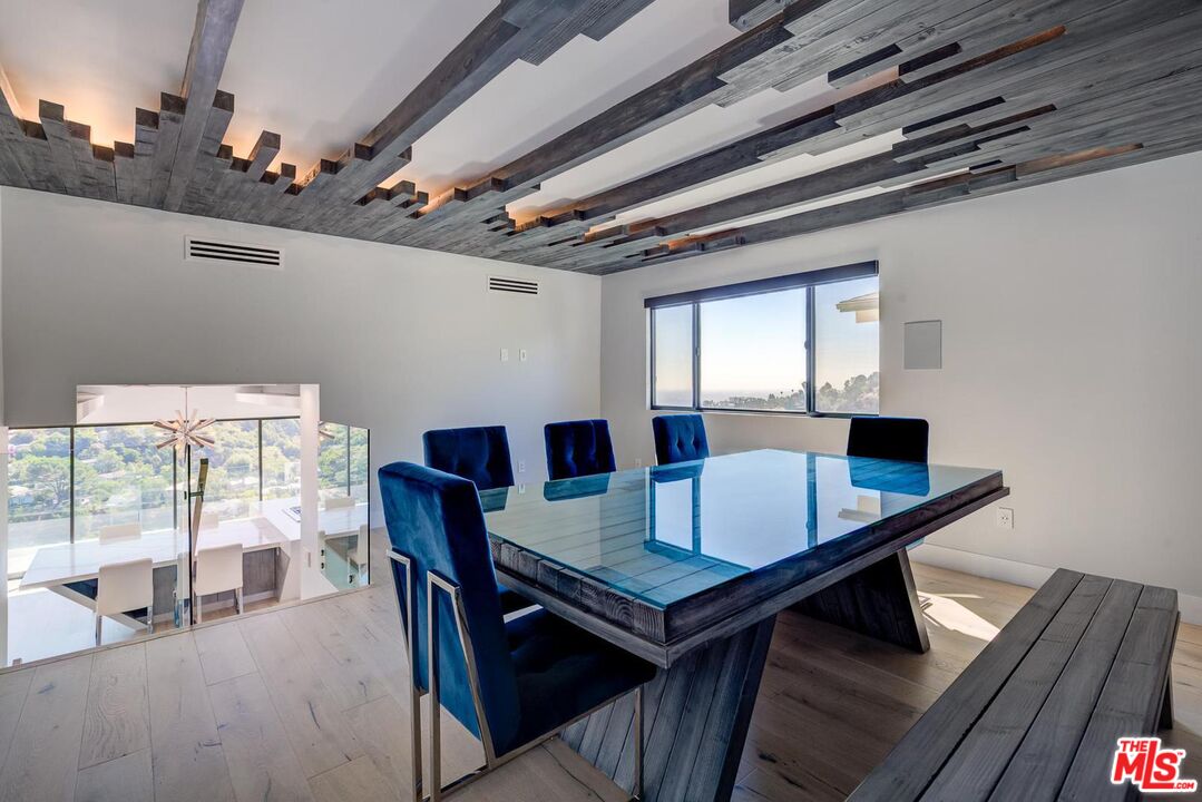 8401 Wyndham Road Los Angeles, CA 90046 - Photo 28 of 34 a view of a dining room with furniture and wooden floor