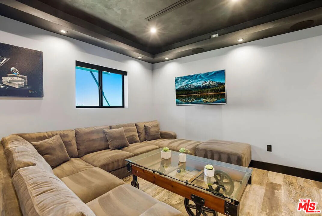 8401 Wyndham Road Los Angeles, CA 90046 - Photo 29 of 34 a living room with furniture and a flat screen tv