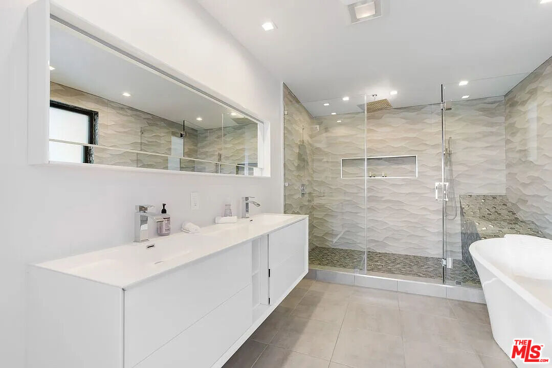 8401 Wyndham Road Los Angeles, CA 90046 - Photo 30 of 34 a bathroom with a double vanity sink mirror and shower