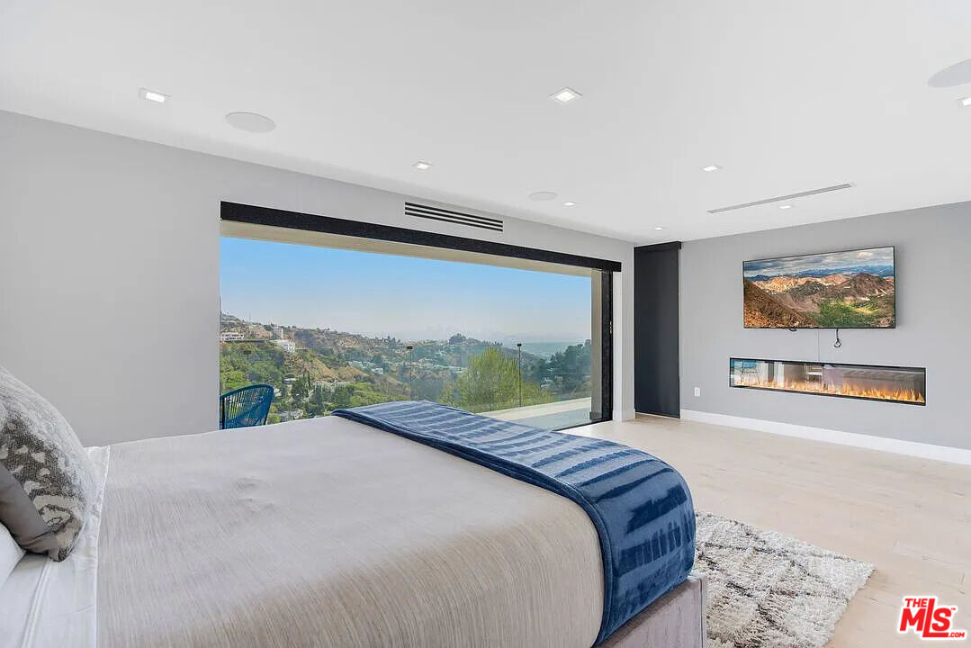 8401 Wyndham Road Los Angeles, CA 90046 - Photo 3 of 34 a bedroom with a large bed and a large window