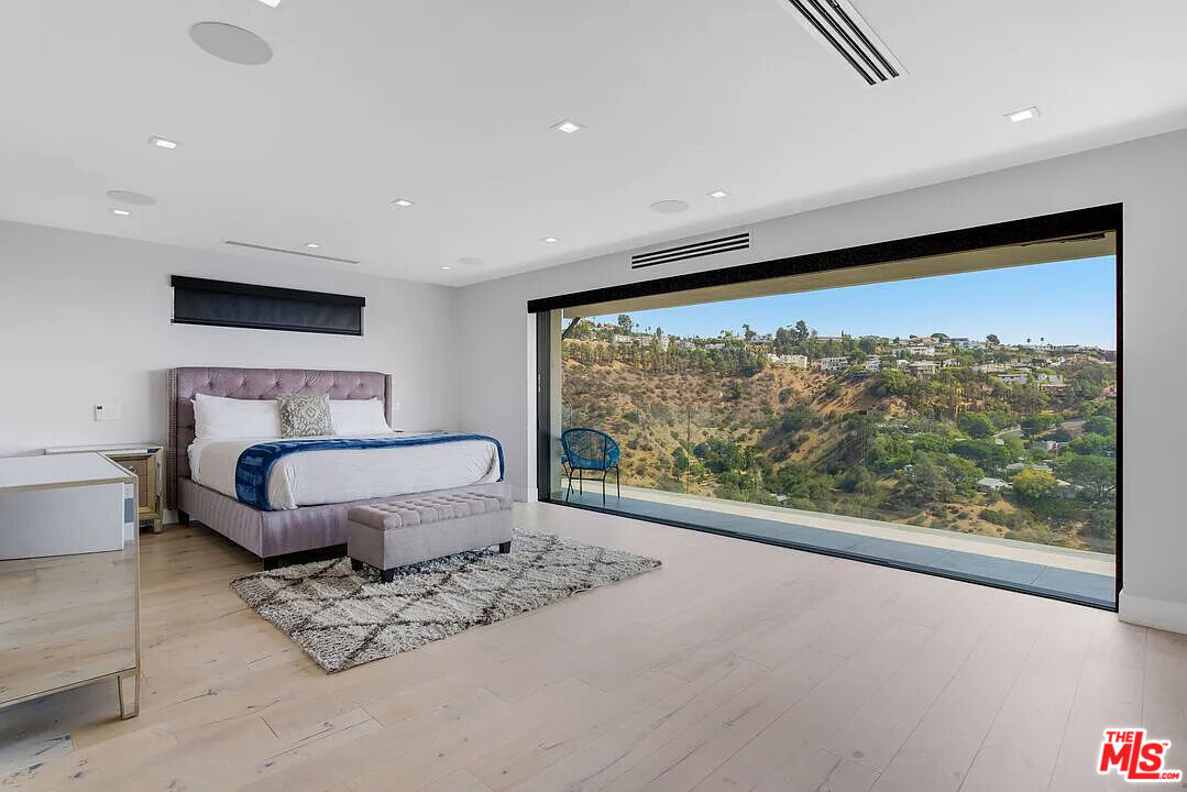 8401 Wyndham Road Los Angeles, CA 90046 - Photo 4 of 34 a bedroom with a large bed and a large window