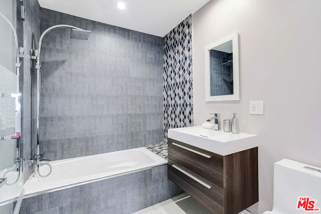 8401 Wyndham Road Los Angeles, CA 90046 - Photo 5 of 34 a bathroom with a sink a mirror and a bathtub