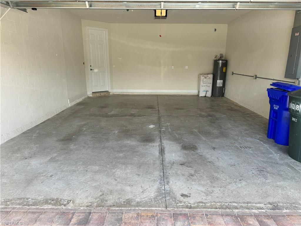 10840 Rutherford Road Fort Myers, FL 33913 - Photo 31 of 35 Garage featuring electric panel, a garage door opener, and water heater
