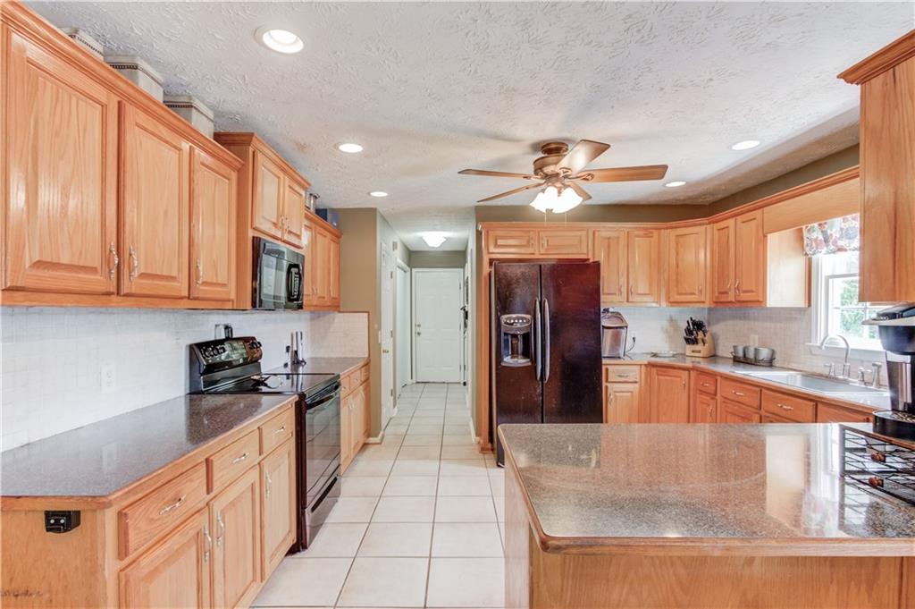 204 Angie Way Bethlehem, GA 30620 - Photo 13 of 42 a large kitchen with stainless steel appliances granite countertop a refrigerator and a sink