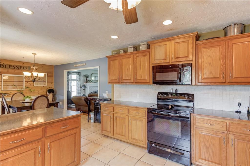 204 Angie Way Bethlehem, GA 30620 - Photo 15 of 42 a kitchen with stainless steel appliances wooden cabinets a stove a sink and a refrigerator