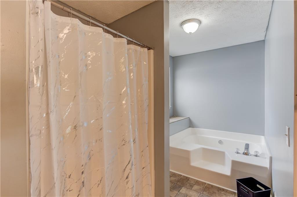204 Angie Way Bethlehem, GA 30620 - Photo 21 of 42 a bathroom with a shower curtain and a sink