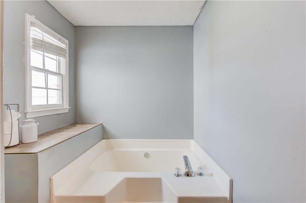 204 Angie Way Bethlehem, GA 30620 - Photo 22 of 42 a bathroom with a tub and a window
