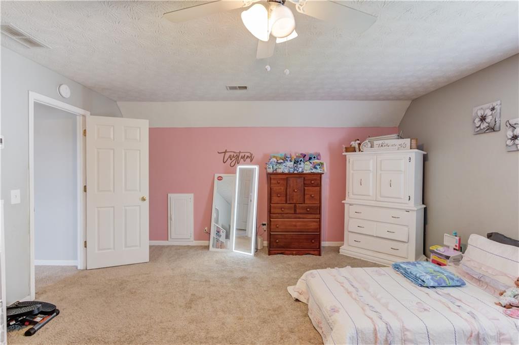 204 Angie Way Bethlehem, GA 30620 - Photo 27 of 42 a bedroom with a bed and a dresser