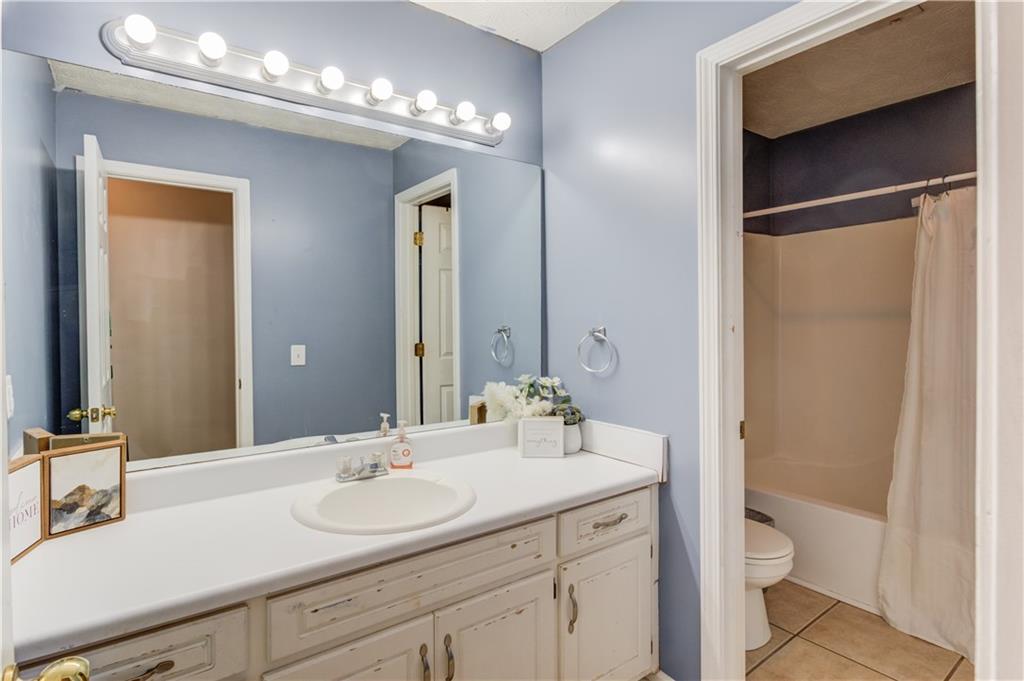 204 Angie Way Bethlehem, GA 30620 - Photo 28 of 42 a bathroom with a toilet a sink and a large mirror