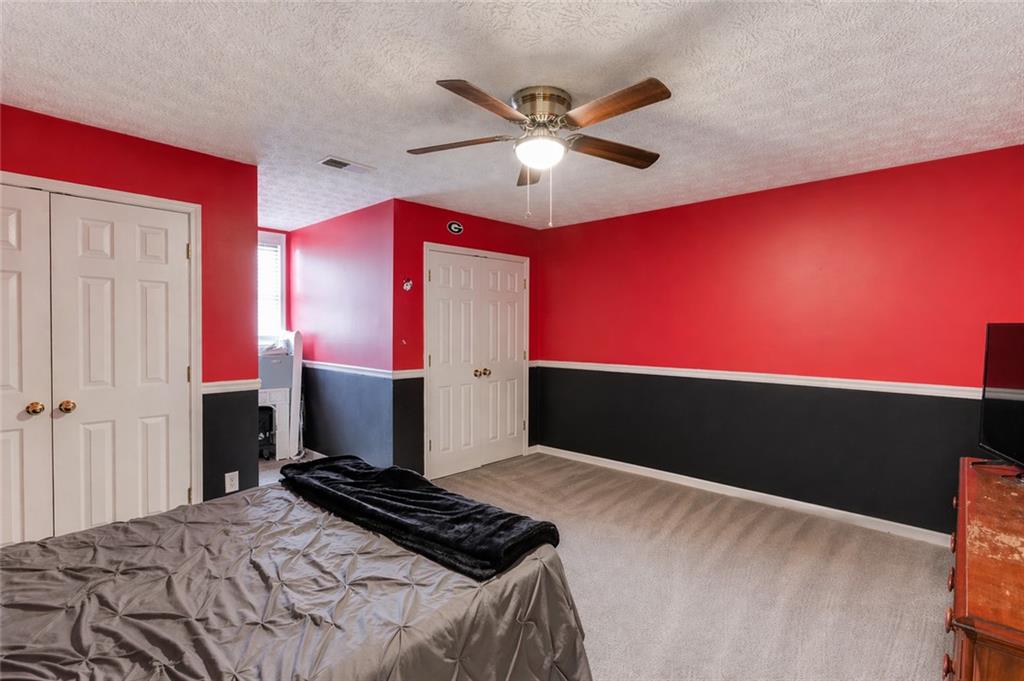 204 Angie Way Bethlehem, GA 30620 - Photo 29 of 42 a bedroom with a bed and a chandelier