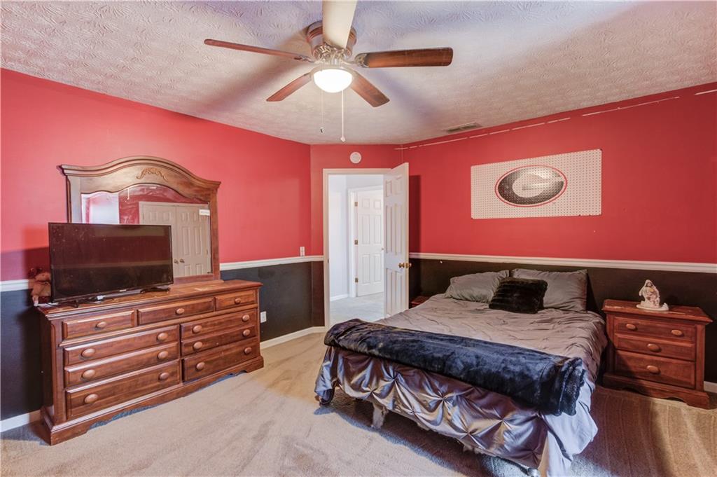 204 Angie Way Bethlehem, GA 30620 - Photo 30 of 42 a bedroom with a bed and a flat screen tv