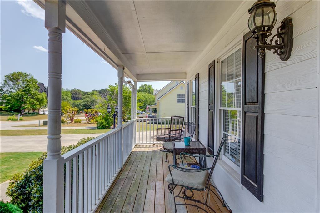 204 Angie Way Bethlehem, GA 30620 - Photo 5 of 42 a view of balcony with chairs and wooden floor
